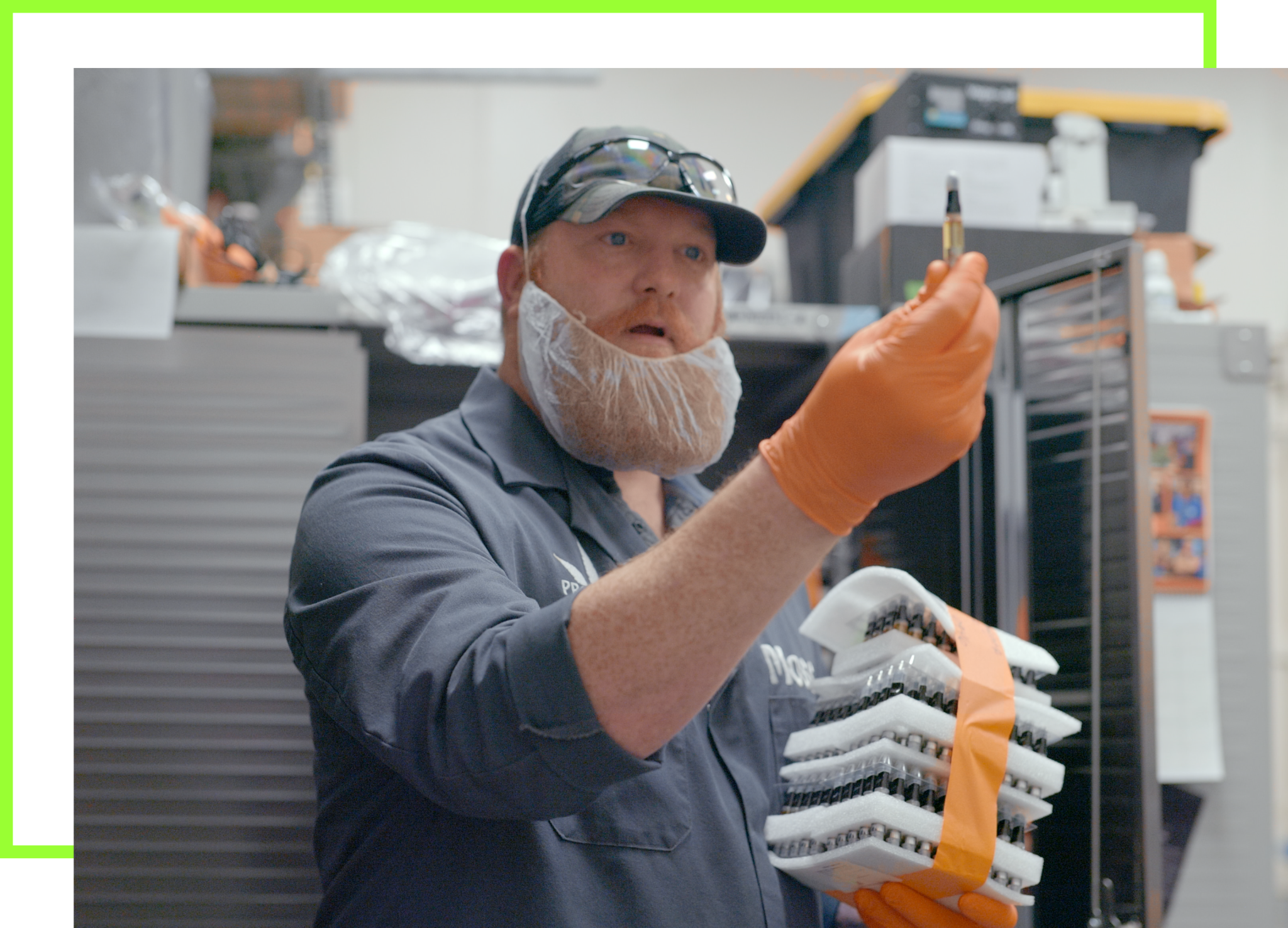 James Moss BOLD Cannabis extraction lab manager holding THC distillate vape cartridge in BOLD’s professional laboratory setting wearing safety equipment.